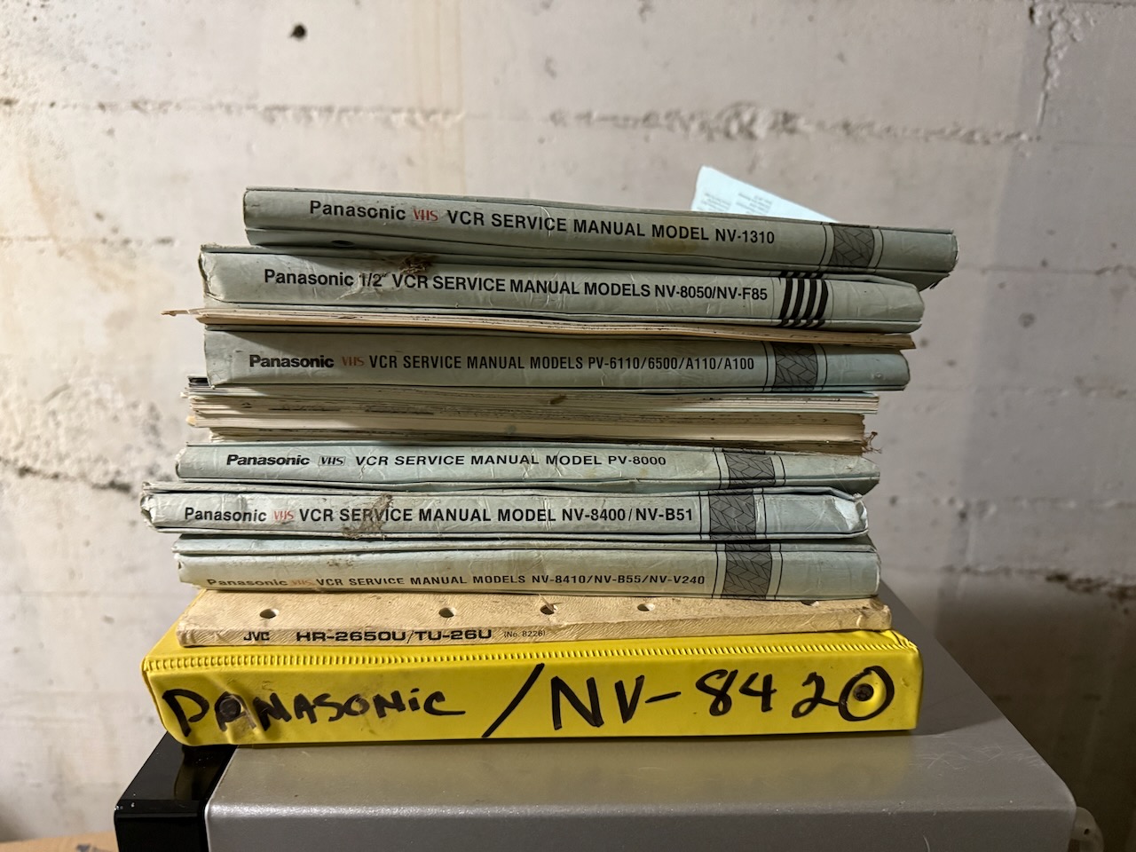 A stack of Panasonic VCR service manuals