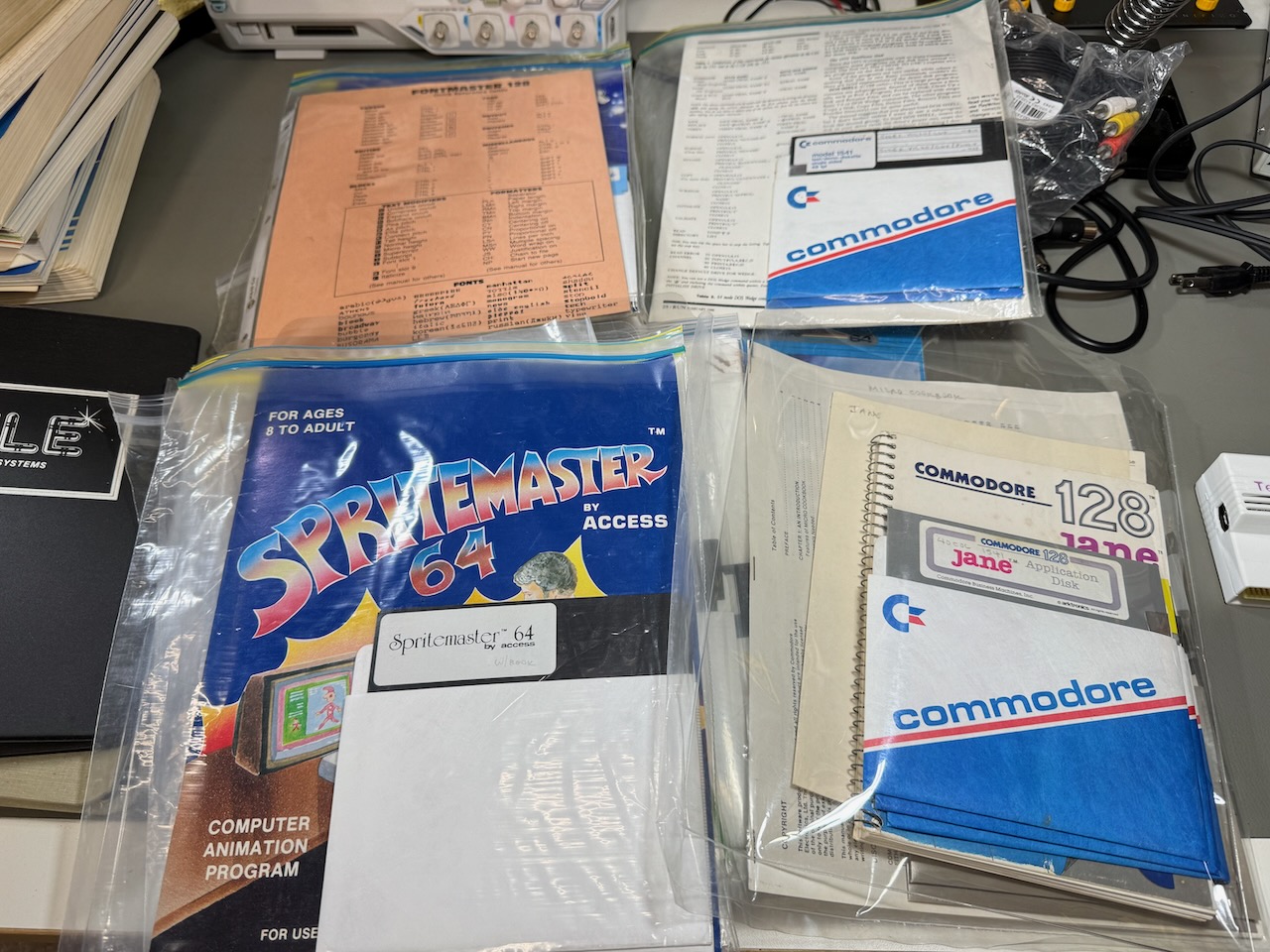 Display of bagged software: Commodore 128 Jane office suite, Spritemaster 64, etc.