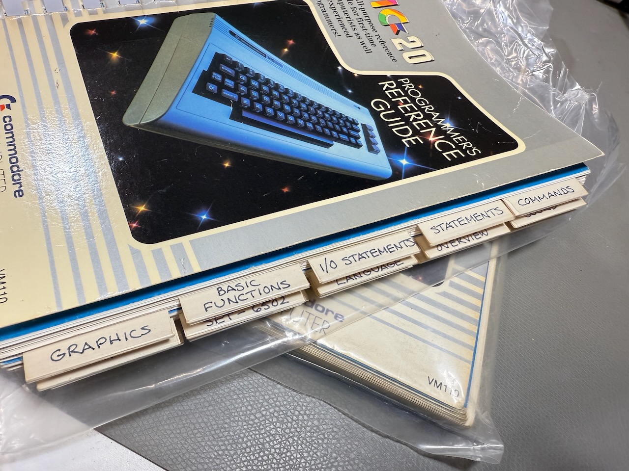 Close-up of VIC-20 Programmers Reference Guide with labelled tabs added
