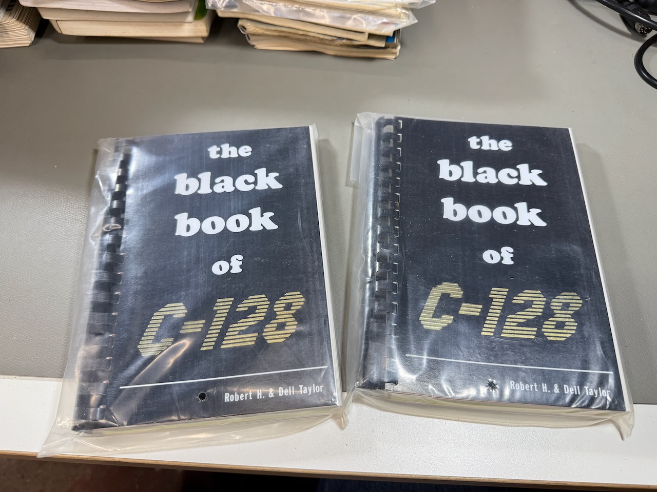 Two copies of The Black Book of C-128, sealed in plastic