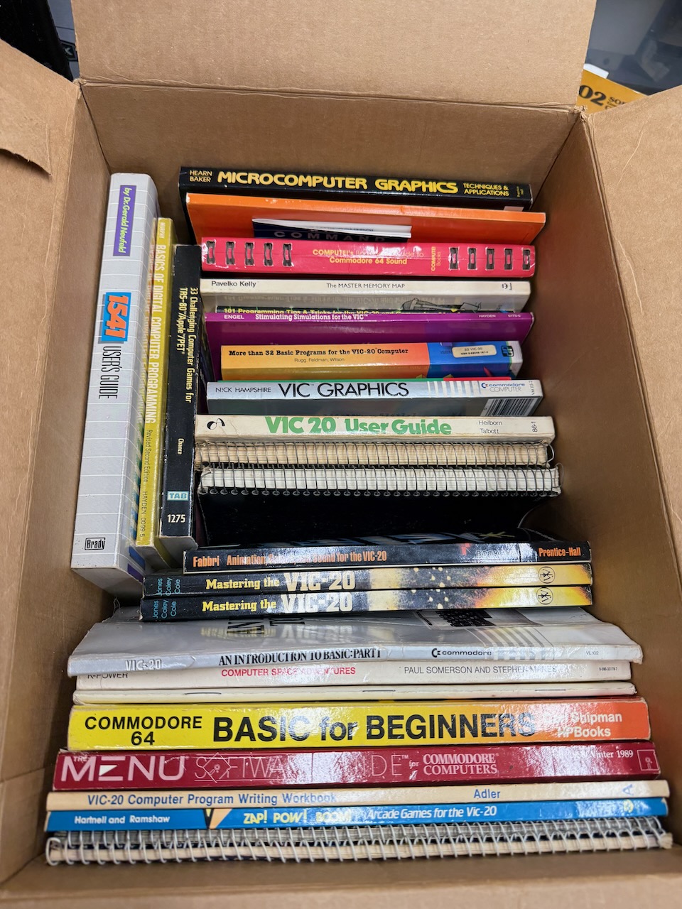 A box of Commodore VIC-20 and C64 programming books