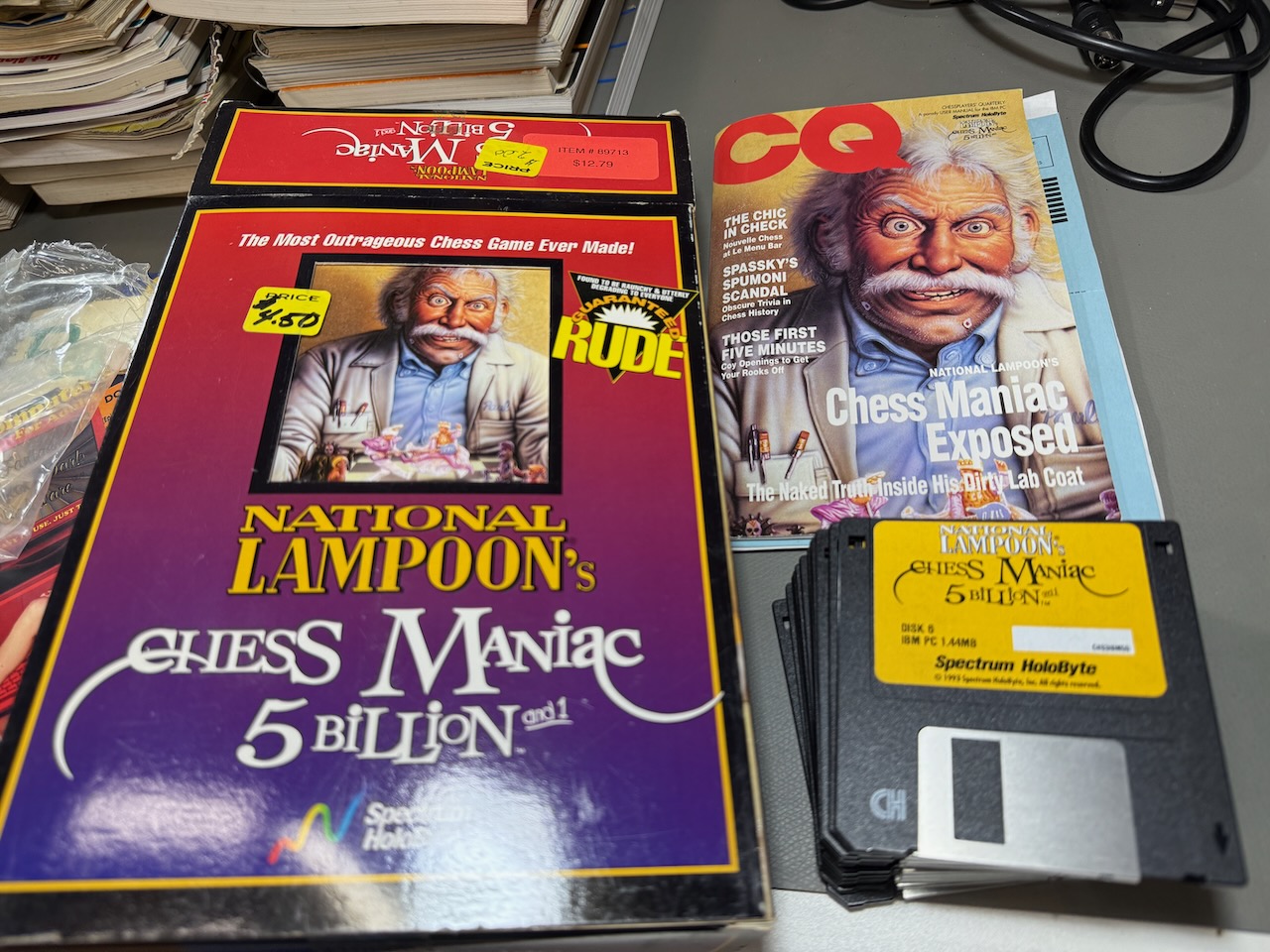 Close-up of contents for Chess Maniac: twelve 3-1/2-inch floppy disks, manual as a parody magazine